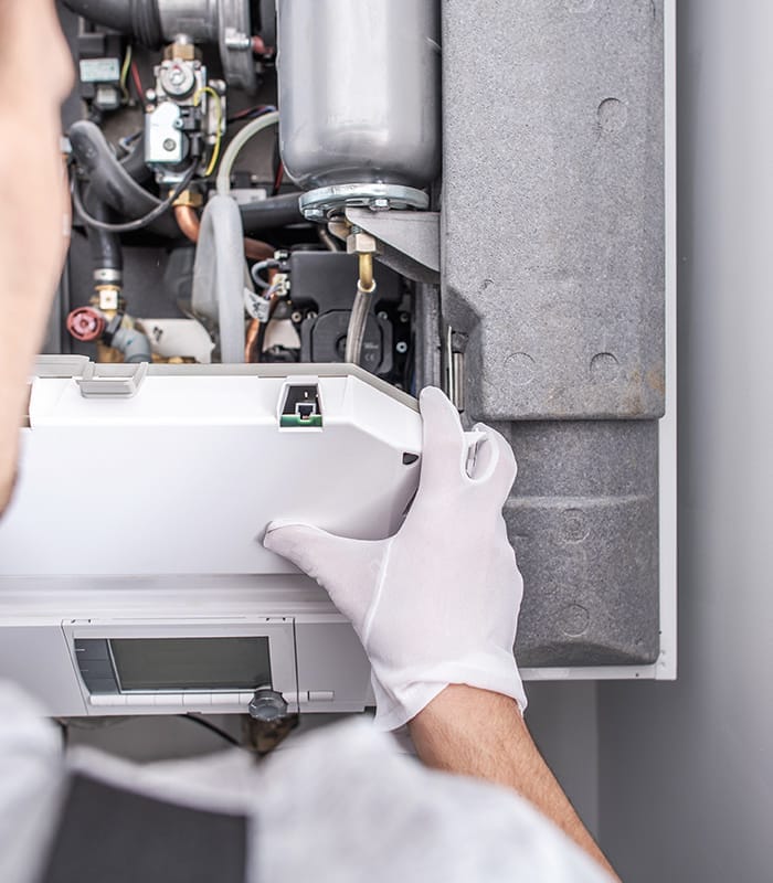 hvac technician close up repairing gas furnace installed at property interiors peyton co hvac technician close up repairing gas furnace installed at property interiors peyton co