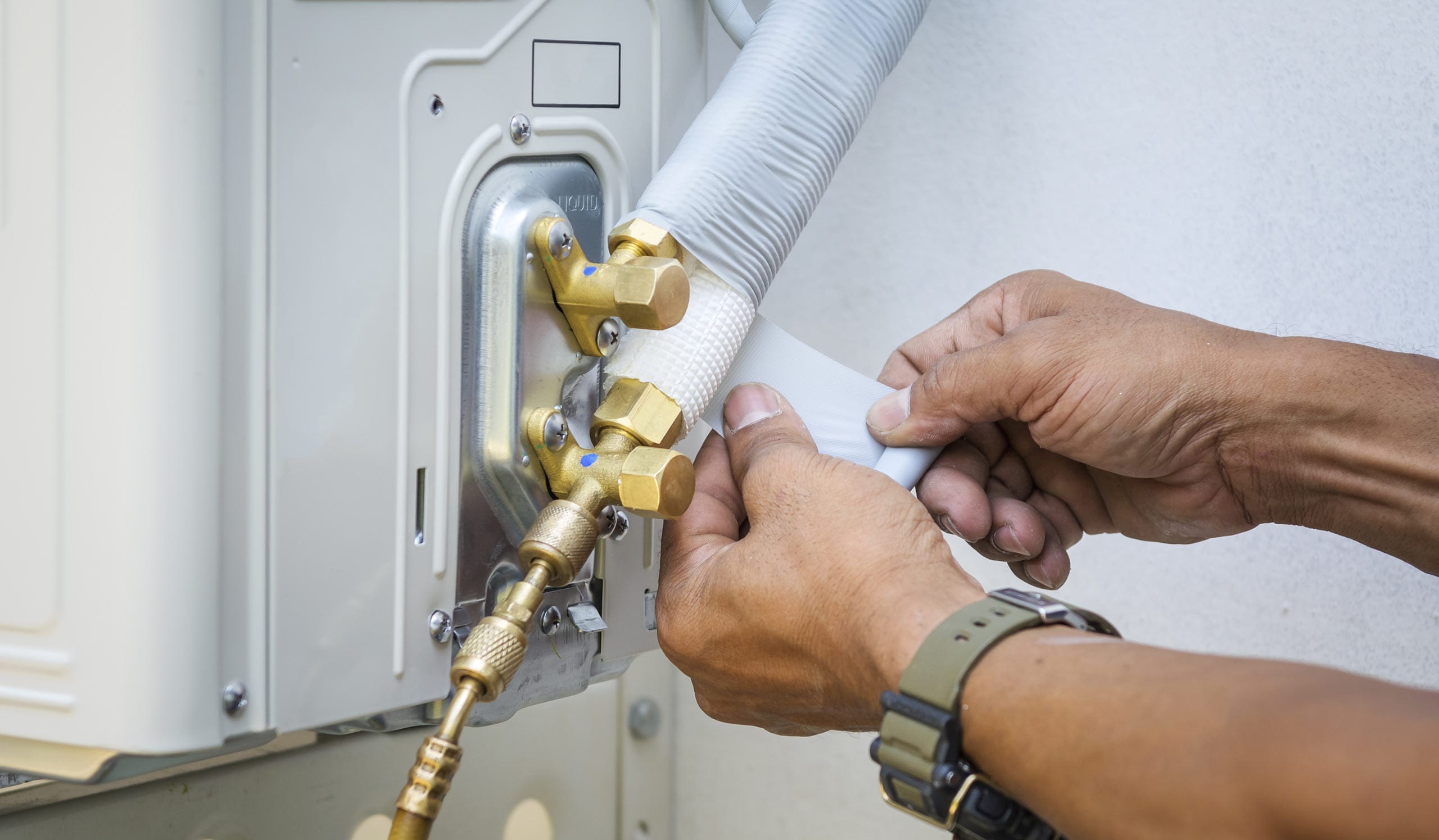 hvac technician hands close up installing air conditioner unit peyton co