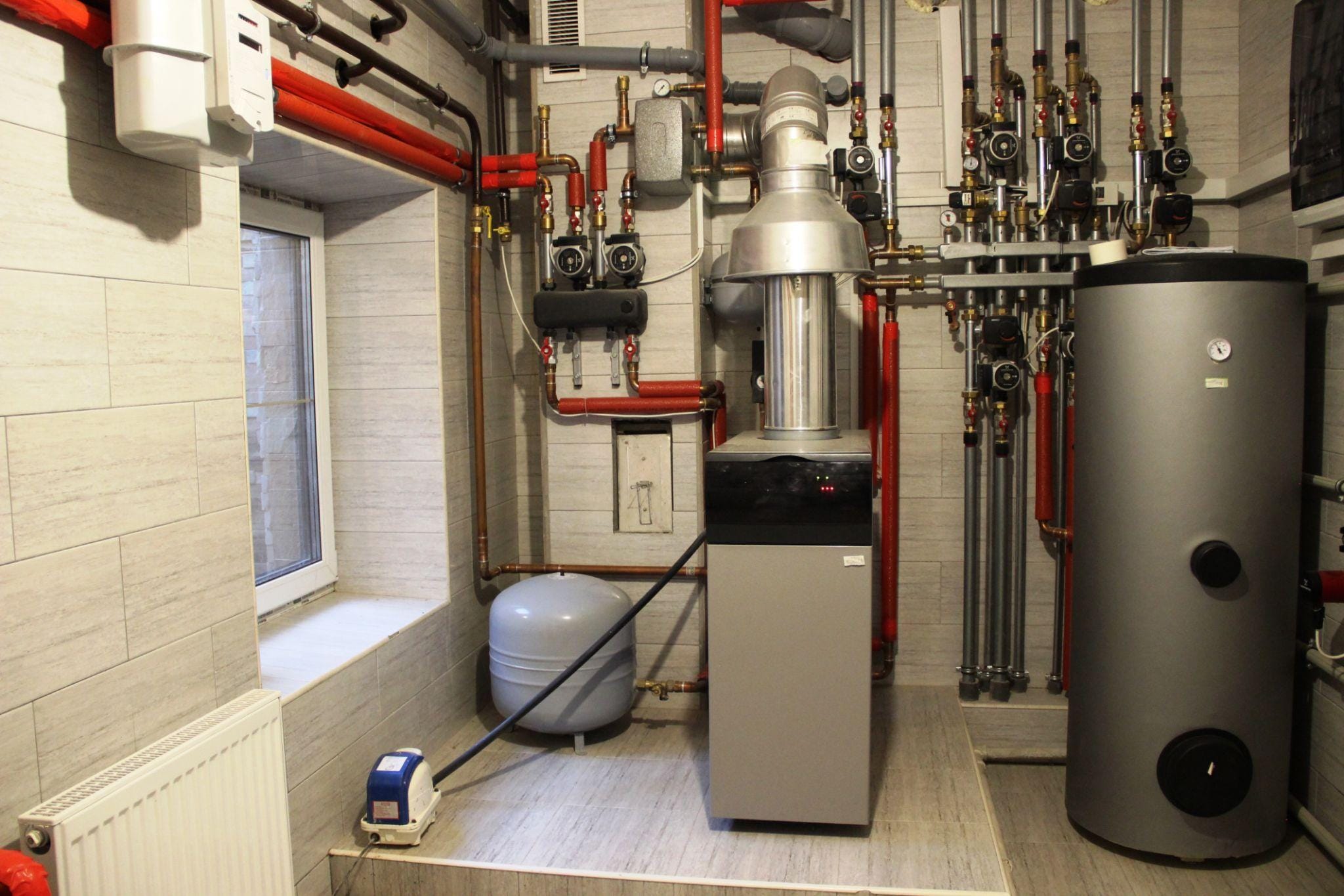 hvac technician close up repairing tankless water heater peyton co